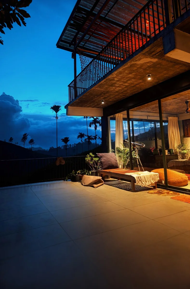 A glowing veranda overlooking mountains at dusk