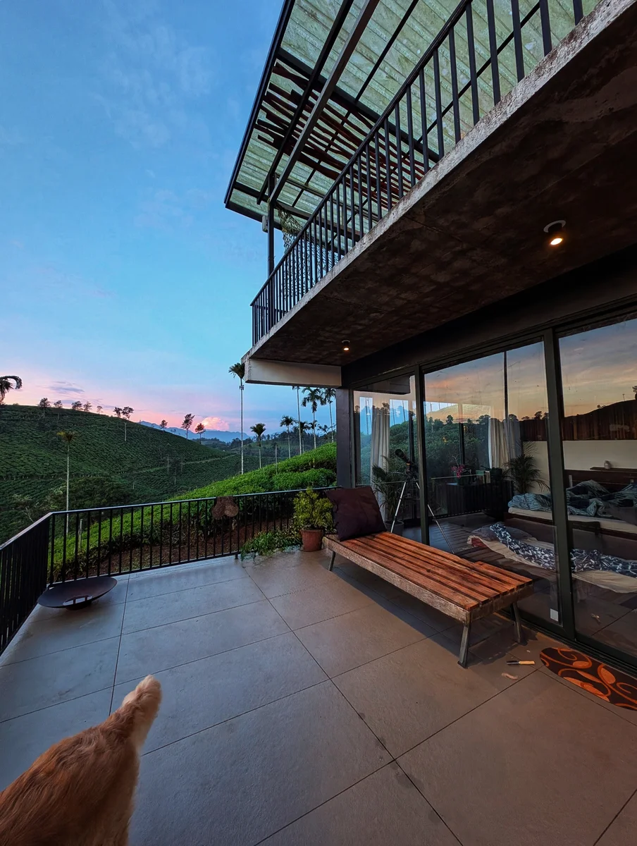 A sheltered terrace opening onto a green landscape