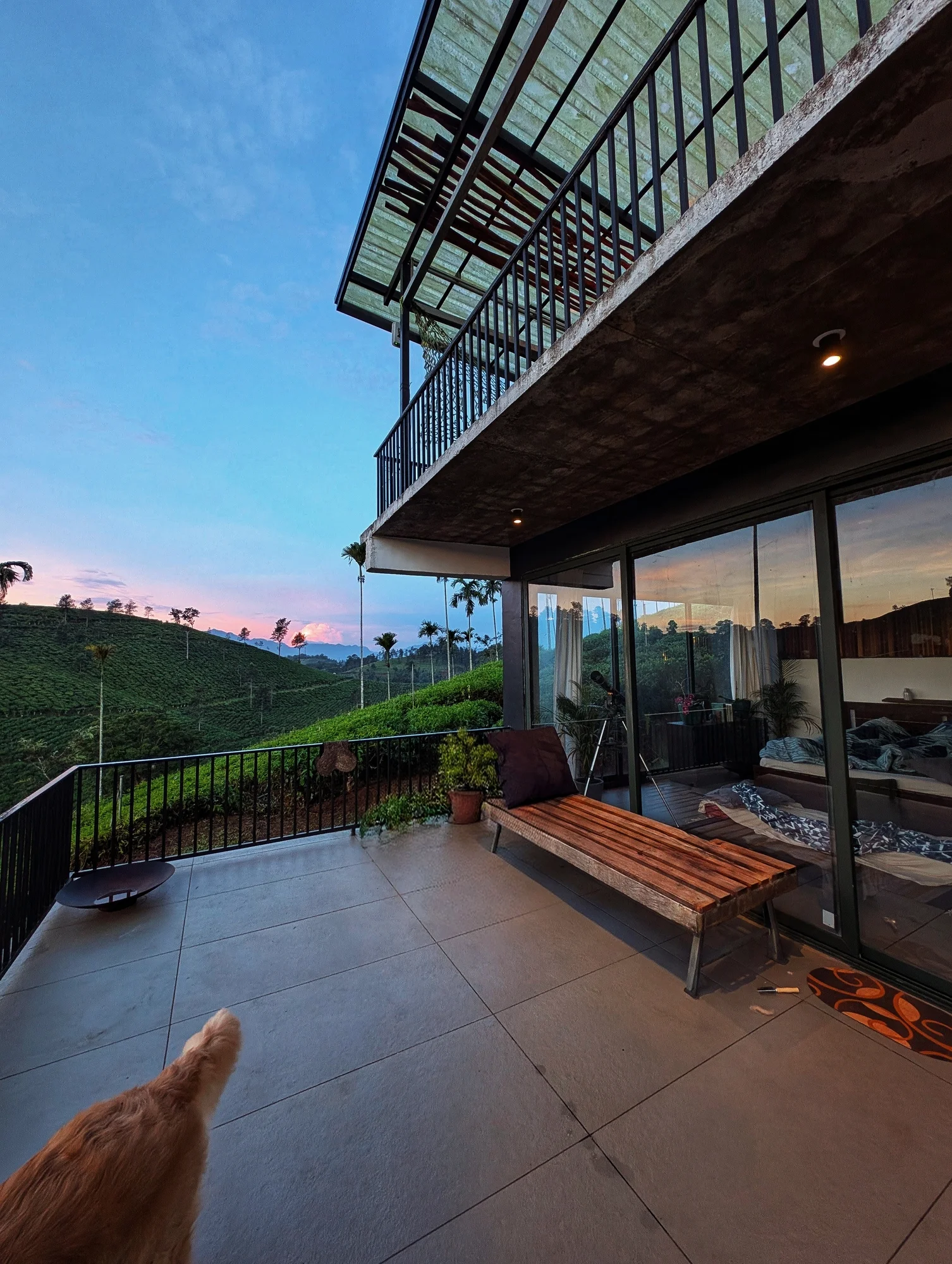 A sheltered terrace opening onto a green landscape