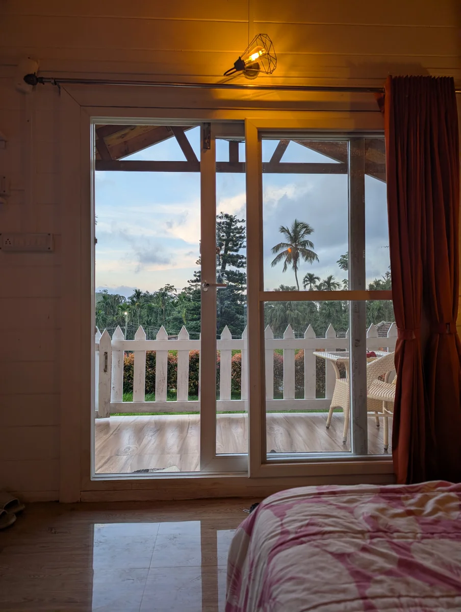 A bedroom doorway framing palms and a balcony